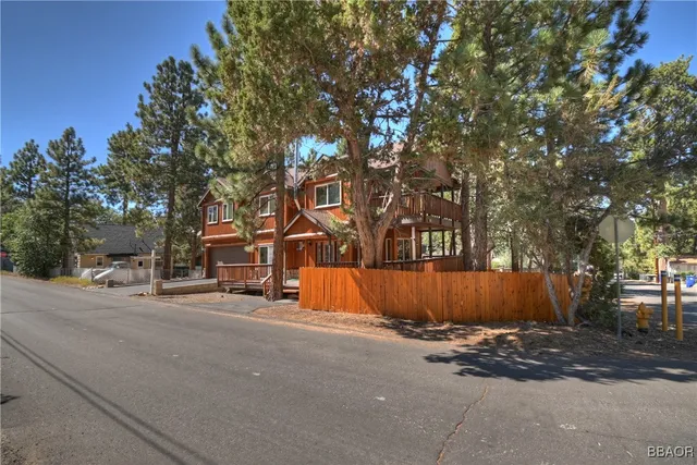 a view of a house with a tree