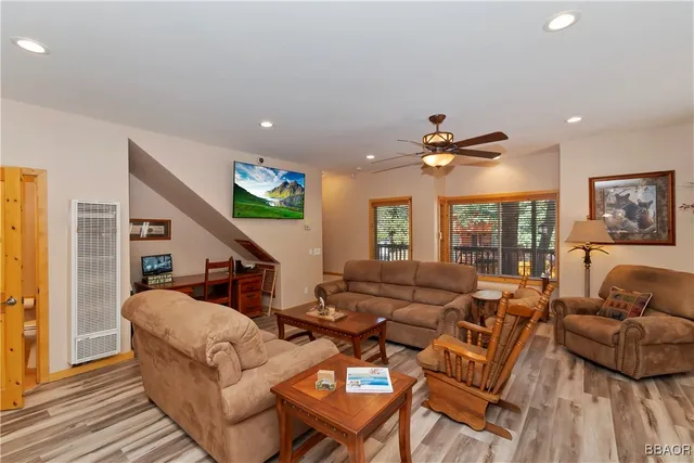 a living room with furniture ceiling fan and a rug