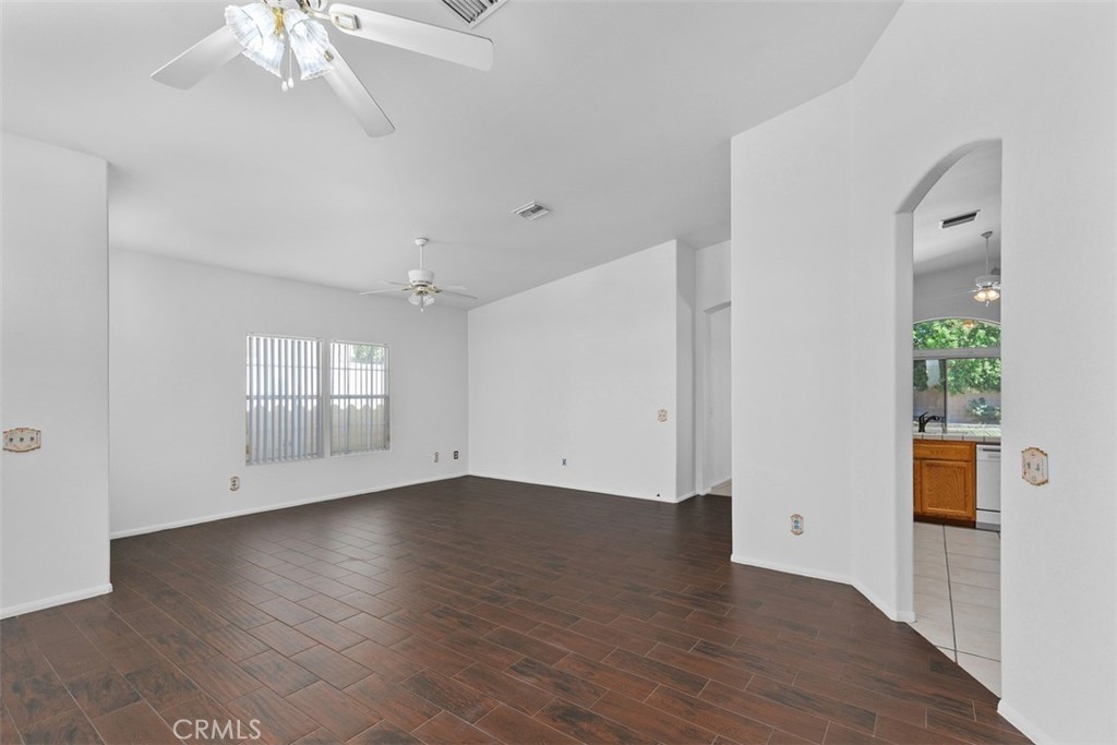 68744 Durango Road Cathedral City, CA 92234 - Photo 11 of 36 an empty room with wooden floor and windows