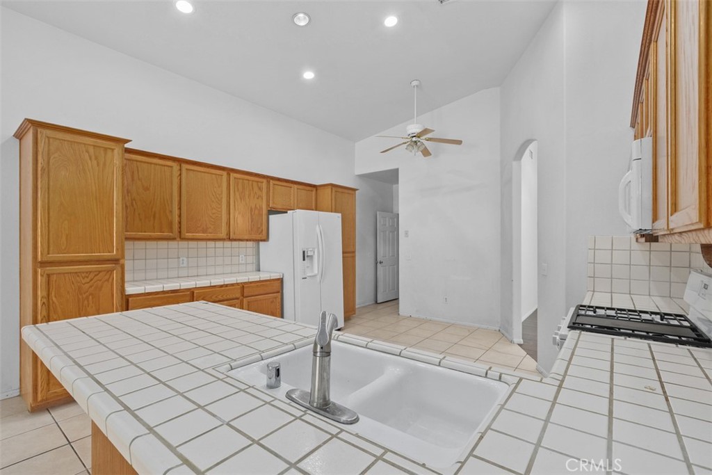 68744 Durango Road Cathedral City, CA 92234 - Photo 17 of 36 a kitchen with stainless steel appliances a refrigerator and a stove top oven