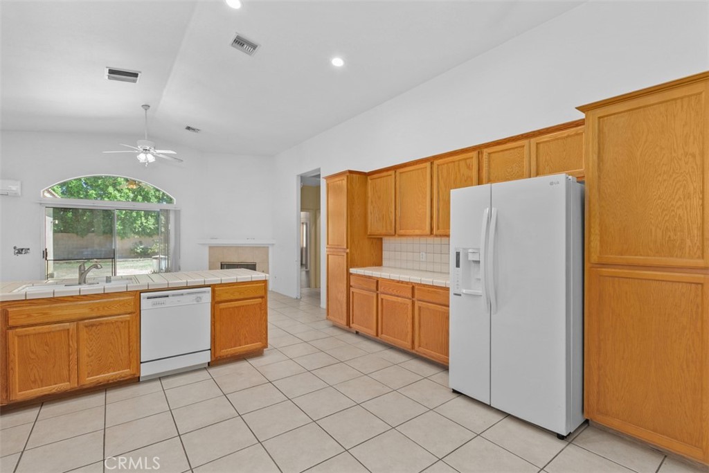 68744 Durango Road Cathedral City, CA 92234 - Photo 18 of 36 a kitchen with granite countertop a refrigerator and a sink