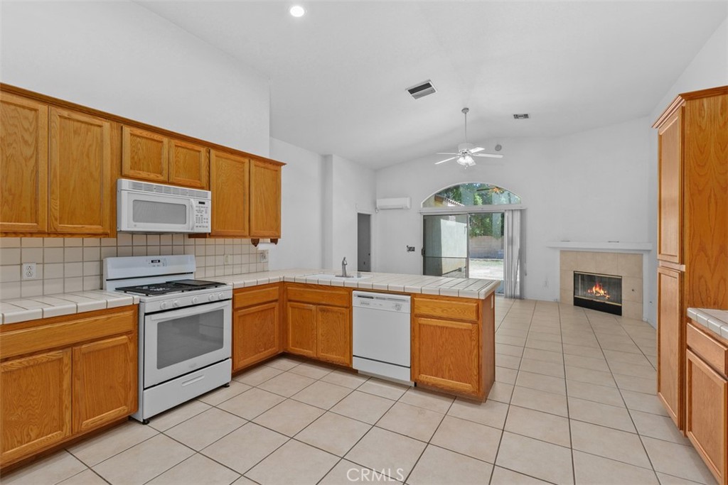 68744 Durango Road Cathedral City, CA 92234 - Photo 19 of 36 a kitchen with stainless steel appliances granite countertop a stove a sink and a microwave