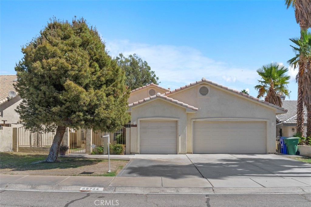 68744 Durango Road Cathedral City, CA 92234 - Photo 2 of 36 a front view of a house with a yard and garage