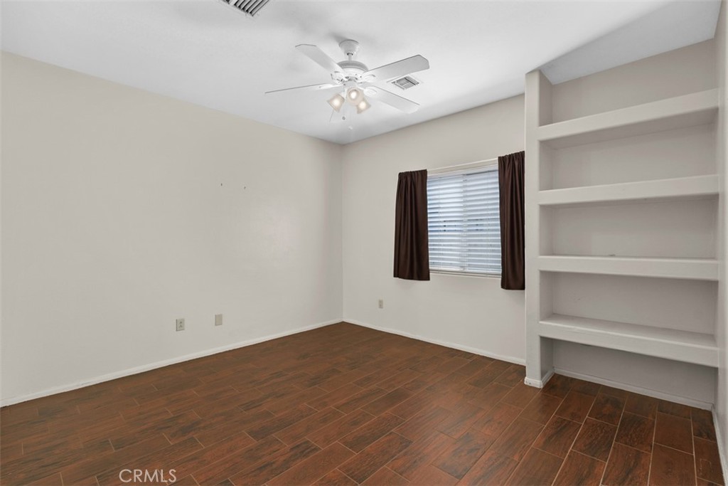 68744 Durango Road Cathedral City, CA 92234 - Photo 21 of 36 a view of an empty room with a window and a ceiling fan