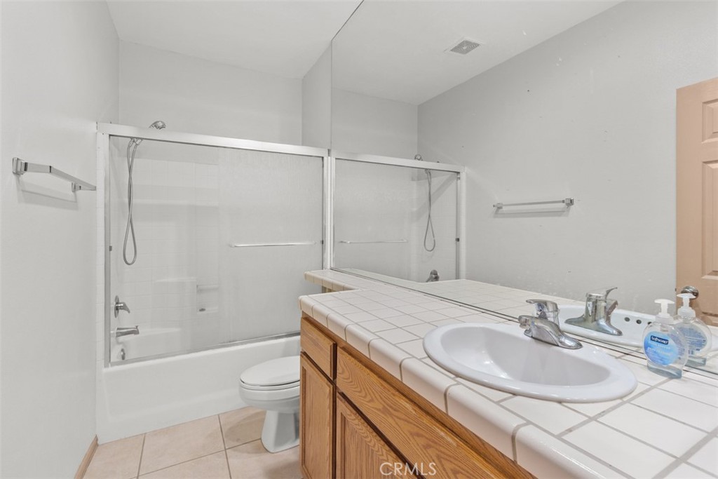68744 Durango Road Cathedral City, CA 92234 - Photo 22 of 36 a bathroom with a granite countertop sink toilet and shower