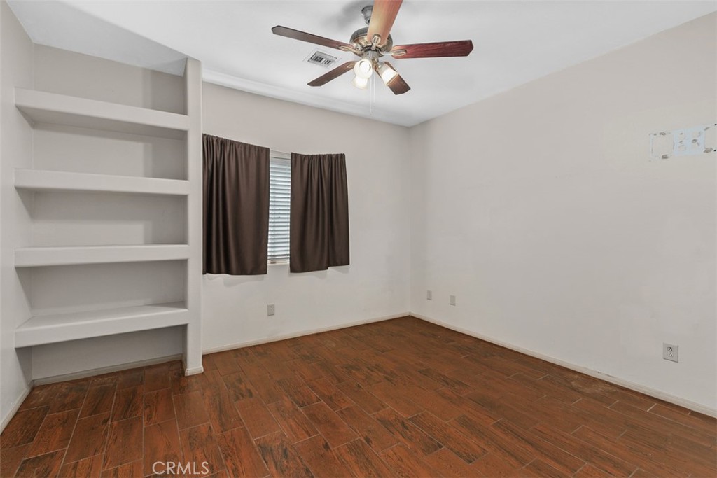 68744 Durango Road Cathedral City, CA 92234 - Photo 23 of 36 a view of an empty room with a window and wooden floor