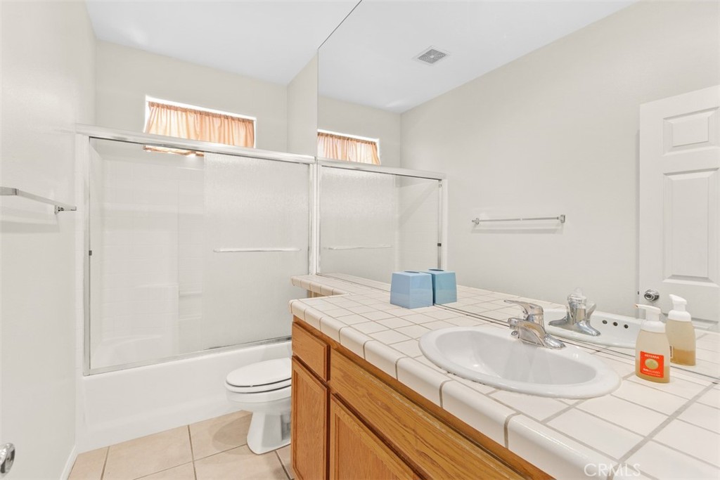 68744 Durango Road Cathedral City, CA 92234 - Photo 25 of 36 a bathroom with a granite countertop sink toilet and shower