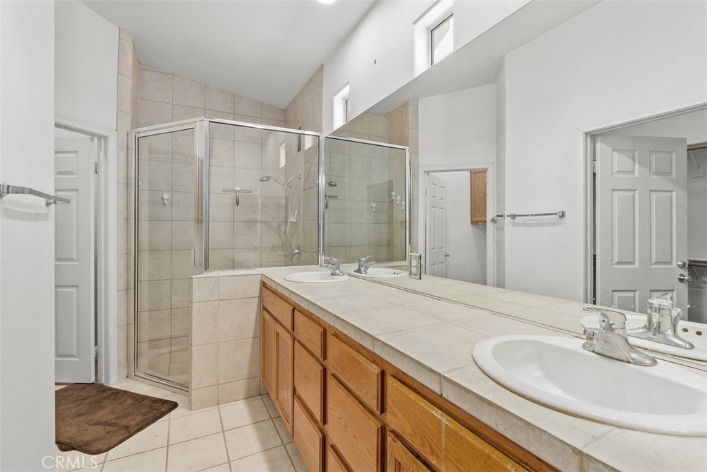 68744 Durango Road Cathedral City, CA 92234 - Photo 28 of 36 a bathroom with a sink double vanity and a shower