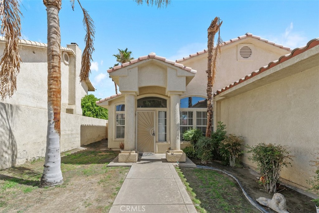 68744 Durango Road Cathedral City, CA 92234 - Photo 5 of 36 a front view of a house with a yard