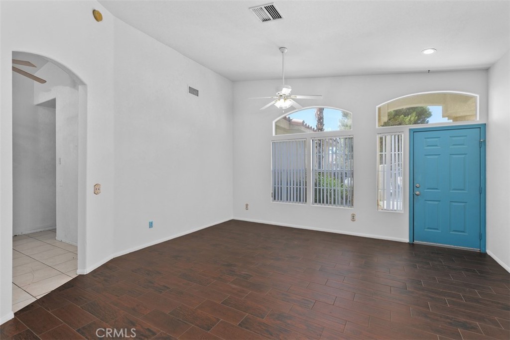 68744 Durango Road Cathedral City, CA 92234 - Photo 10 of 36 an empty room with chandelier fan and windows