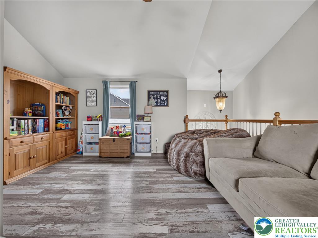 2628 Levans Road Coplay, PA 18037 - Photo 28 of 54 A versatile open-concept living space features light wood flooring and high vaulted ceilings.
