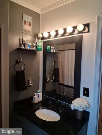 a bathroom with a sink a mirror and shower