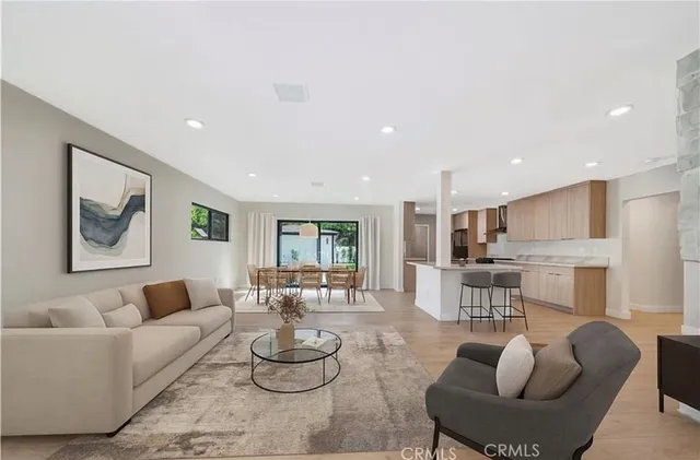 a view of a patio with table and chairs potted plants and large tree