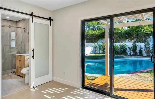 a large bedroom with a bed and large window