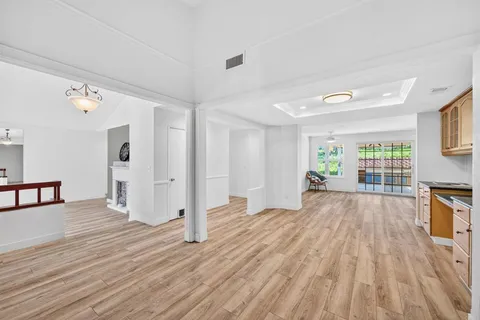 a large kitchen with granite countertop a large counter top stainless steel appliances and cabinets