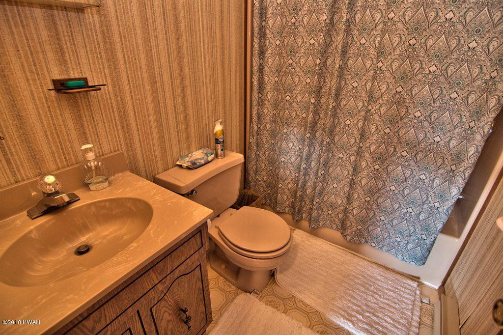 2327 Brookfield Road Lake Ariel, PA 18436 - Photo 13 of 53 a bathroom with a sink a toilet and mirror
