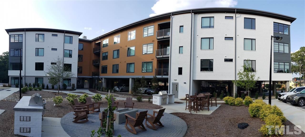 a front view of a building with outdoor seating