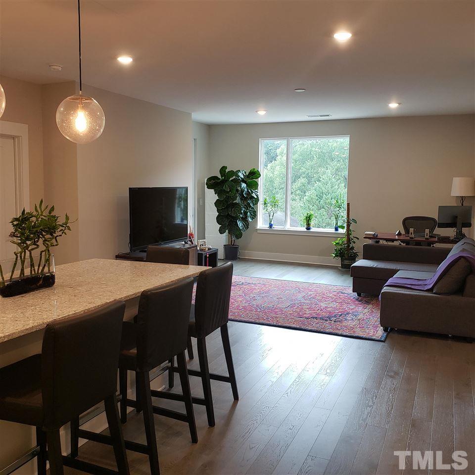 105 Chatham Walk Lane, Unit 404 Cary, NC 27511 - Photo 3 of 12 a dining room with furniture and wooden floor