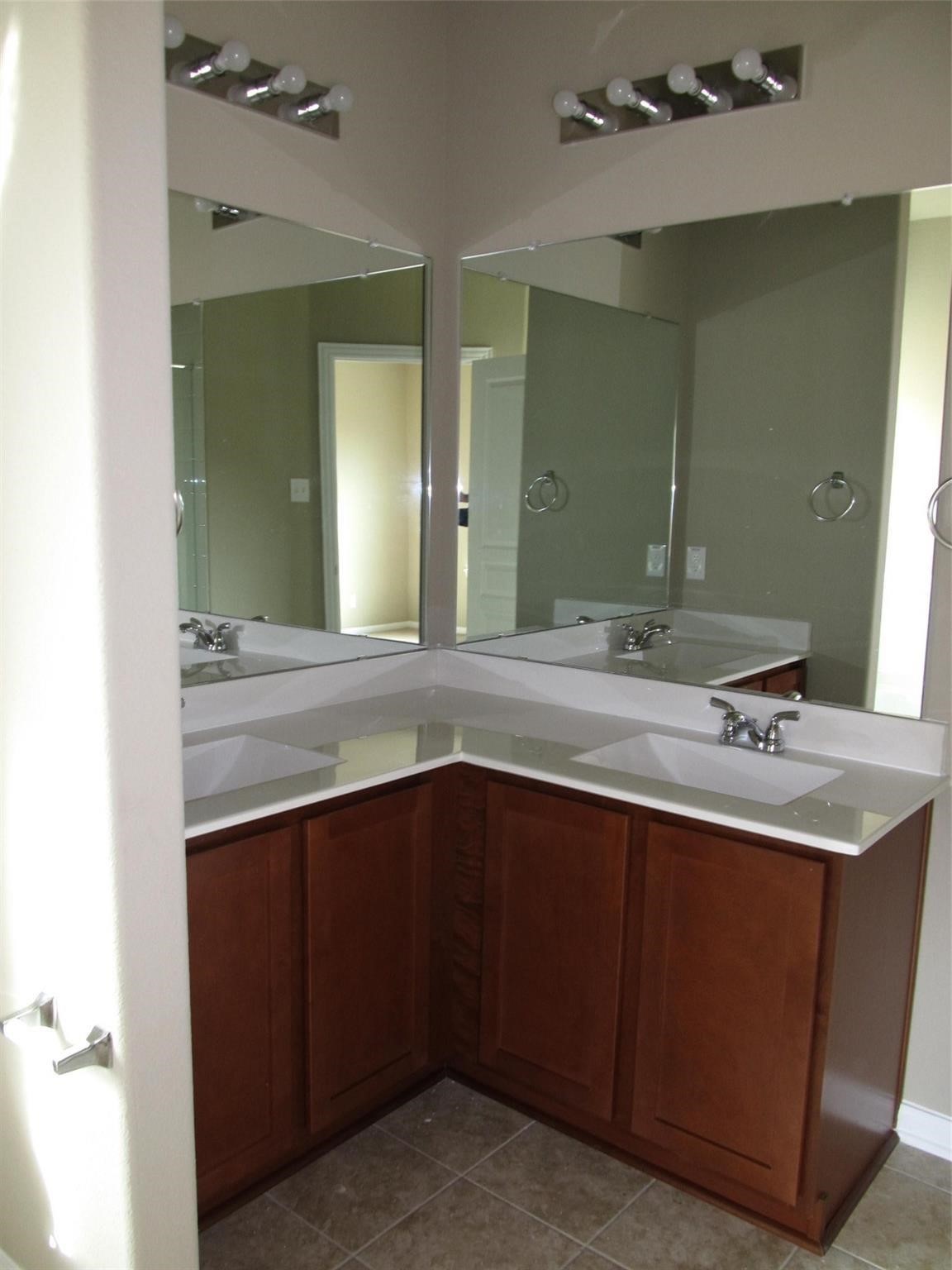 2310 Thunderbolt Peak Drive Rosharon, TX 77583 - Photo 15 of 27 a bathroom with a double vanity sink and a mirror