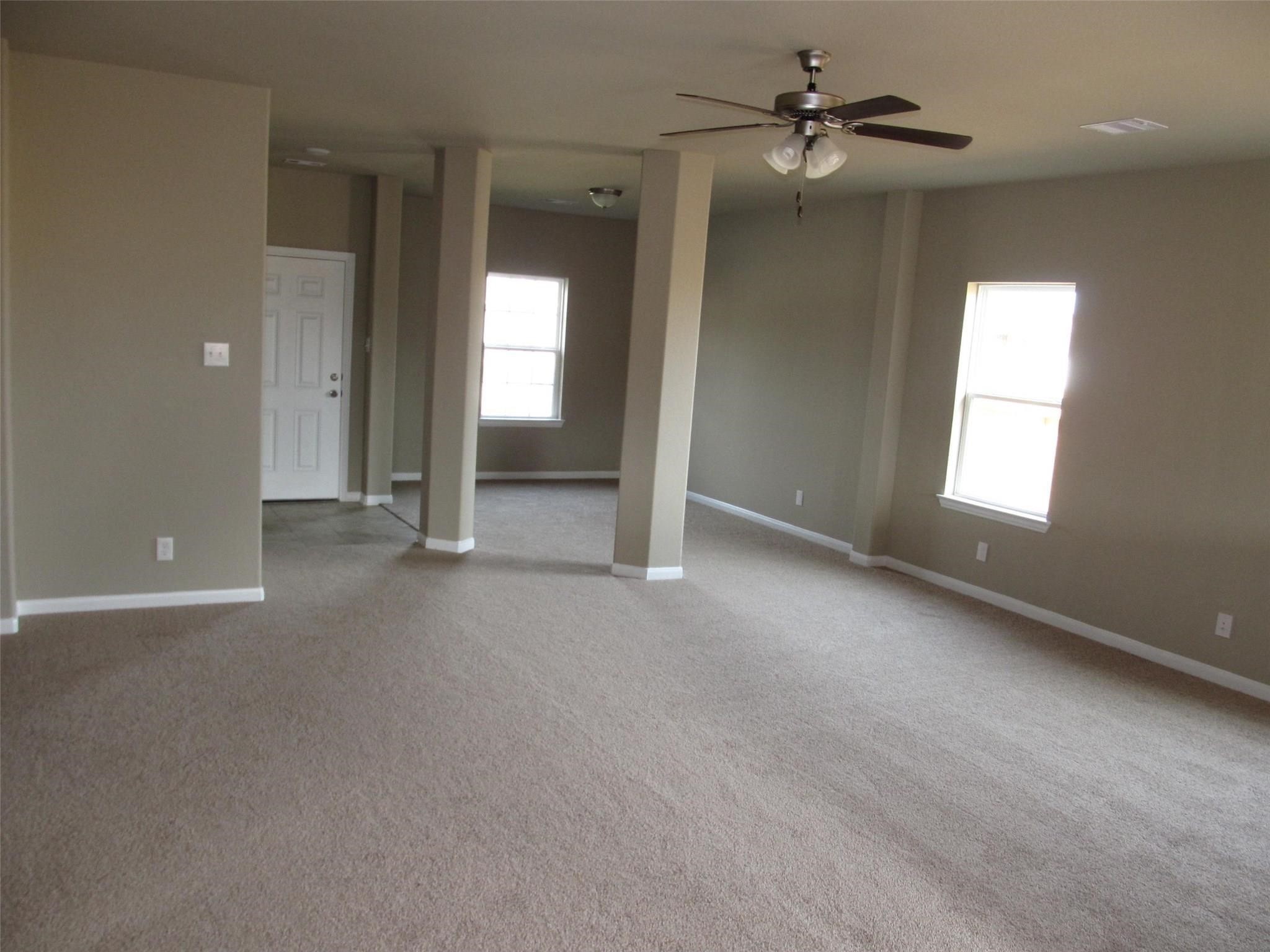 2310 Thunderbolt Peak Drive Rosharon, TX 77583 - Photo 22 of 27 an empty room with windows and fan