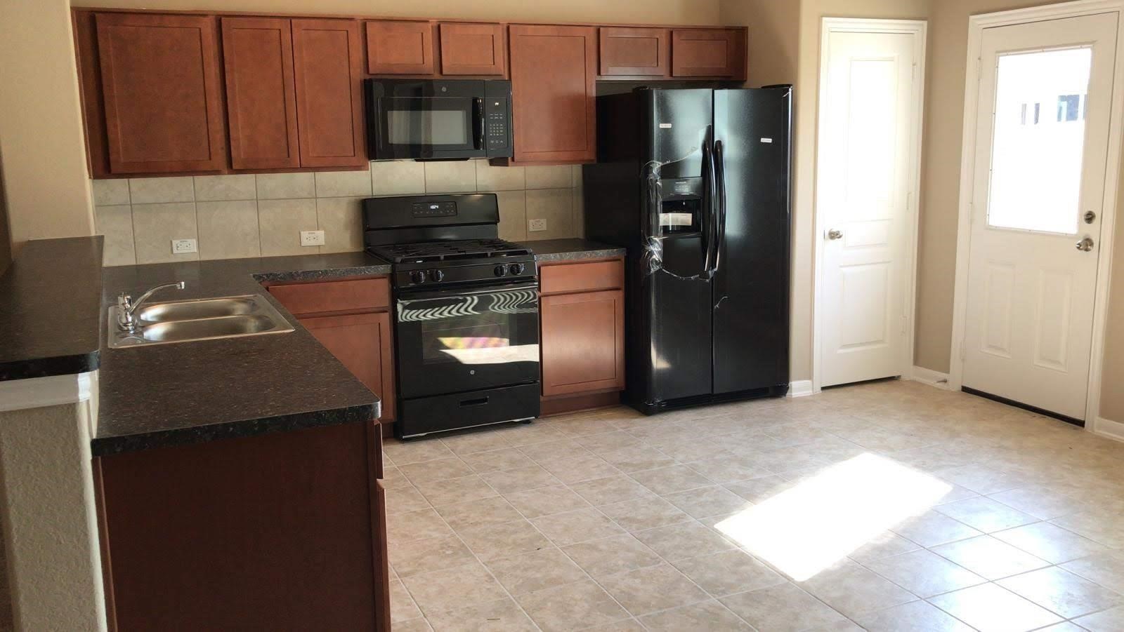 2310 Thunderbolt Peak Drive Rosharon, TX 77583 - Photo 4 of 27 a kitchen with cabinets and stainless steel appliances
