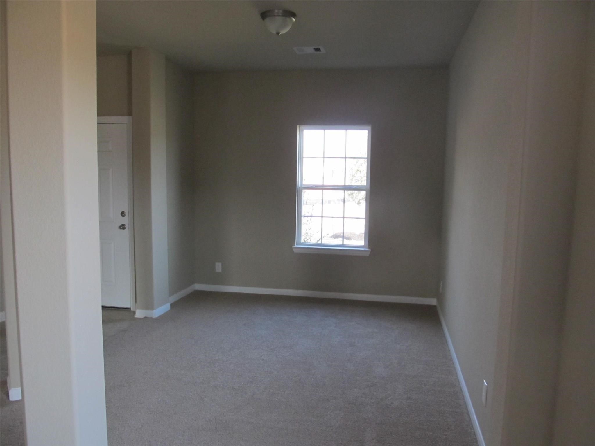 2310 Thunderbolt Peak Drive Rosharon, TX 77583 - Photo 5 of 27 an empty room with a window