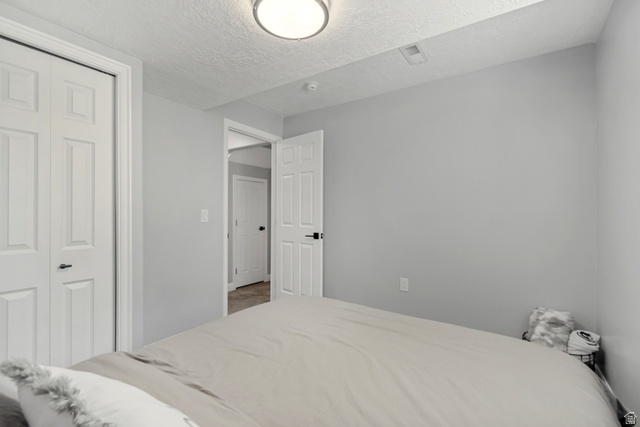 4752 South 4075th Street West Roy, UT 84067 - Photo 21 of 28 Bedroom featuring light gray walls, white trim, and a flush mount ceiling light