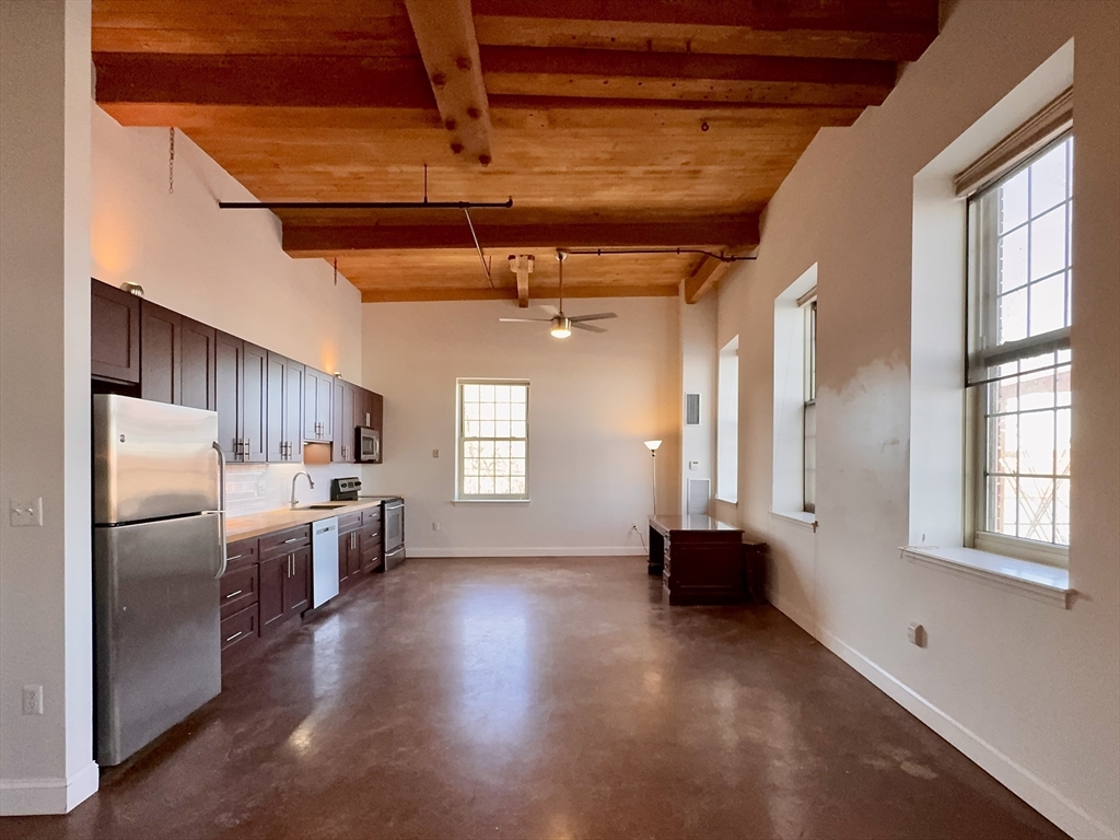 35 Riverwalk Way, Unit R302 Lowell, MA 01854 - Photo 2 of 20 a view of a kitchen with refrigerator and window