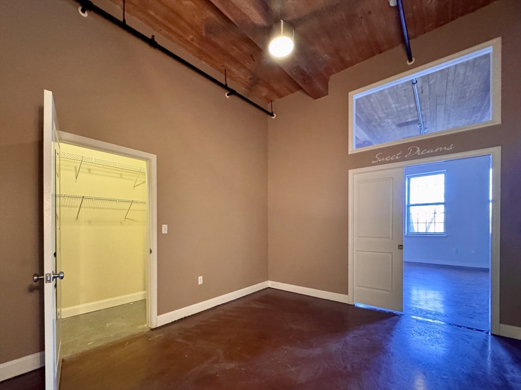 35 Riverwalk Way, Unit R302 Lowell, MA 01854 - Photo 6 of 20 an empty room with wooden floor and windows