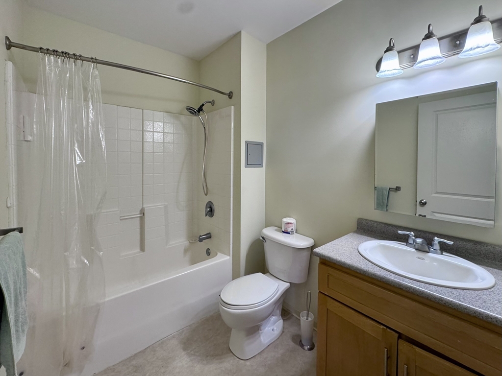 35 Riverwalk Way, Unit R302 Lowell, MA 01854 - Photo 8 of 20 a bathroom with a sink a toilet and shower