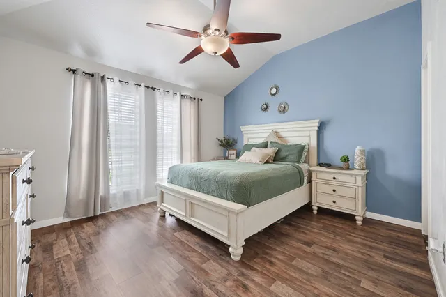 a bedroom with a large bed and a window