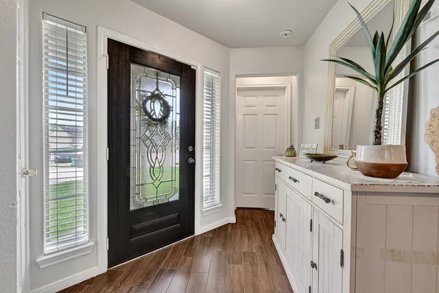 a kitchen with a refrigerator a sink and cabinets