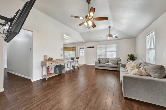 a living room with furniture and kitchen view