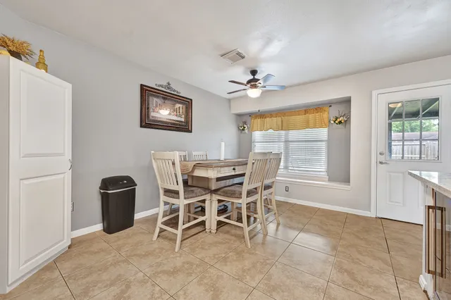a dining room with furniture and window