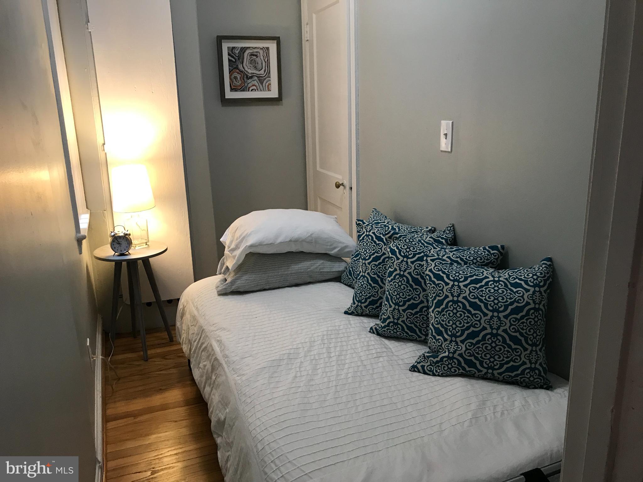 731 13th Street Northeast, Unit 1 Washington, DC 20002 - Photo 9 of 16 a bedroom with a bed and wooden floor