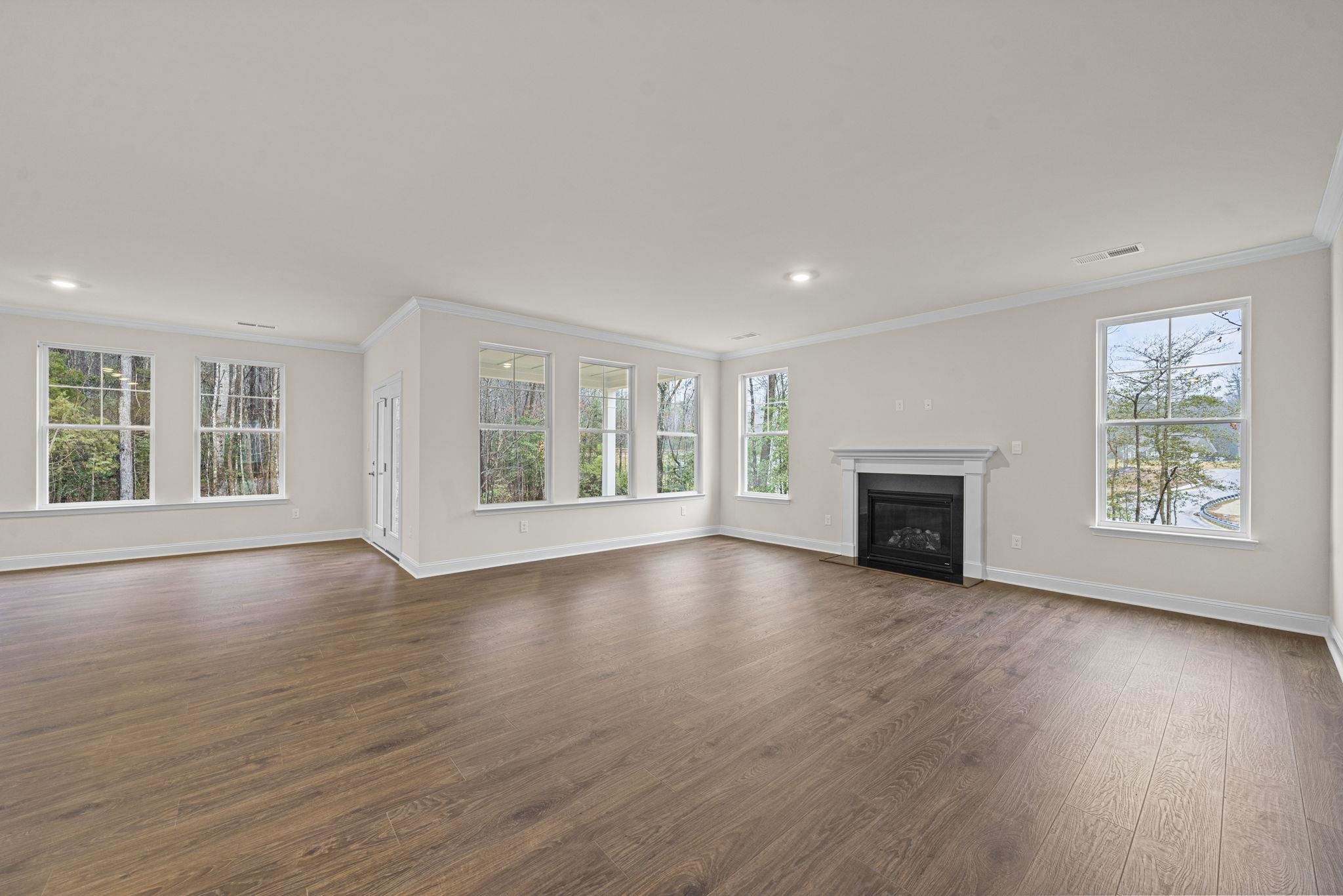 128 Jaspers Lane Stuarts Draft, VA 24477 - Photo 3 of 26 a view of an empty room with wooden floor and a window