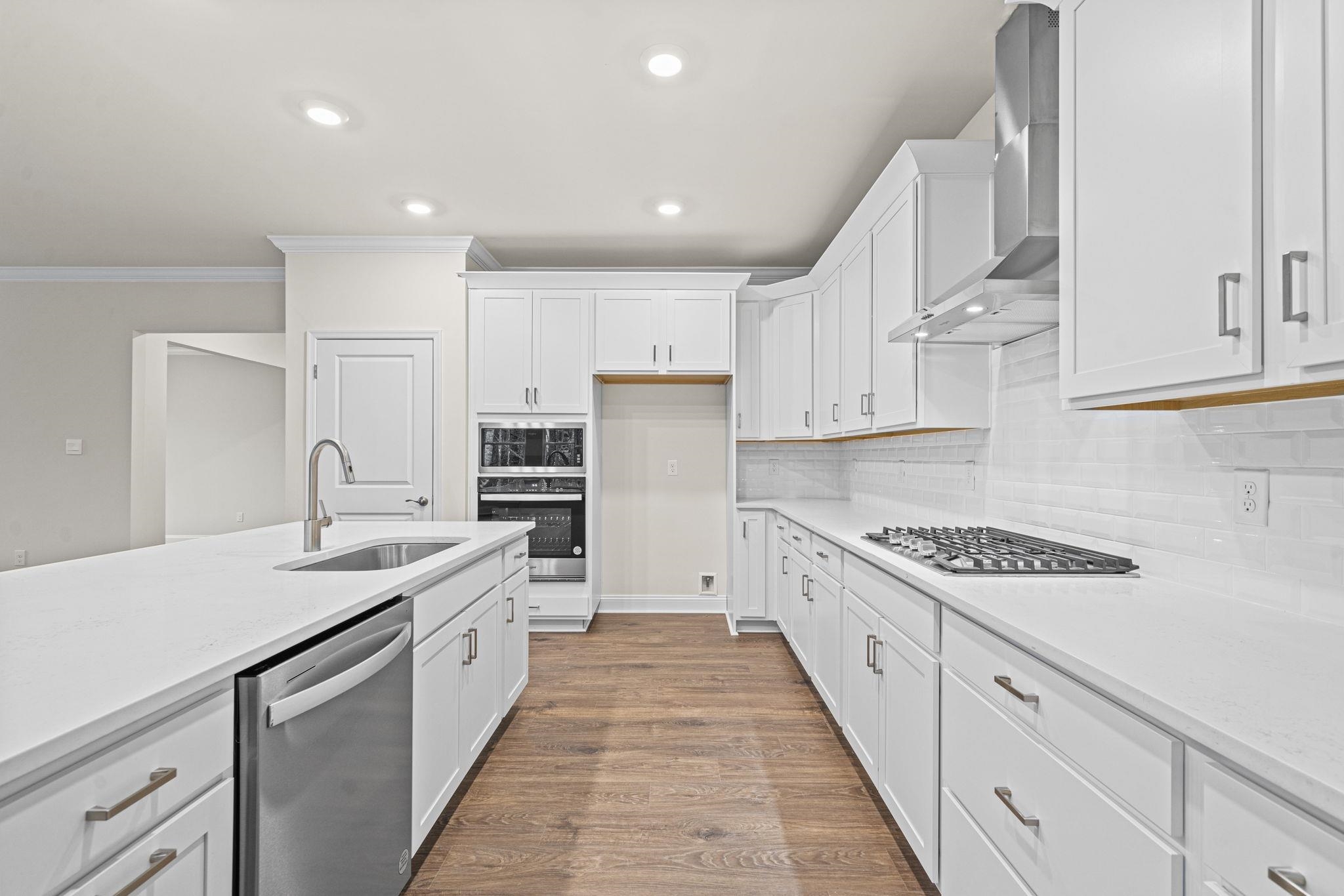 128 Jaspers Lane Stuarts Draft, VA 24477 - Photo 7 of 26 a kitchen with stainless steel appliances granite countertop a sink and cabinets with wooden floor