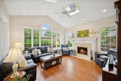 a living room with furniture fireplace and a large window
