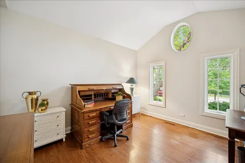 a view of a workspace with furniture and a window