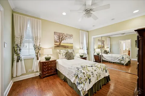 a bedroom with a large bed and a chandelier