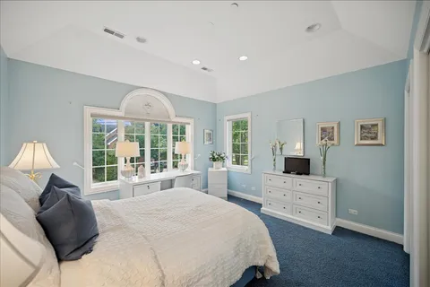 a spacious bedroom with a large bed and a window