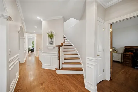 a view of entryway with wooden floor and stairs