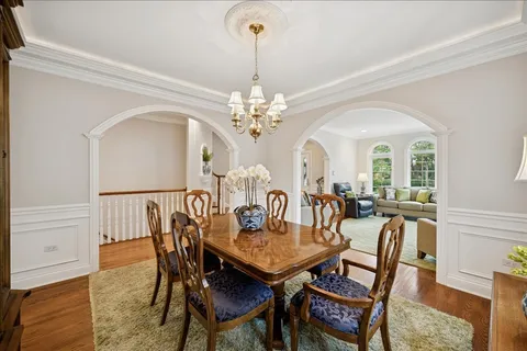 a view of a dining room with furniture and chandelier