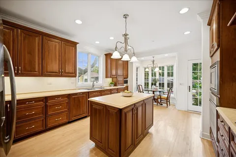 a large kitchen with kitchen island granite countertop a stove oven and a sink with granite countertops