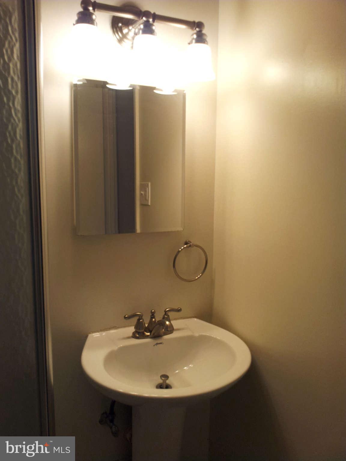8639 Victoria Road Springfield, VA 22151 - Photo 11 of 17 a bathroom with a sink and mirror
