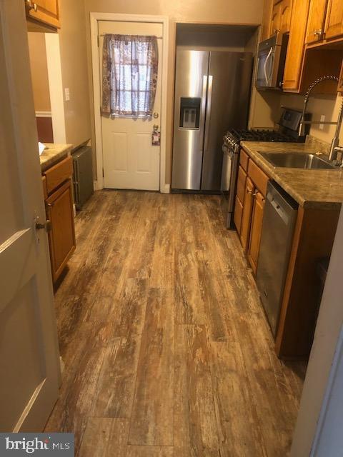 3804 Kimble Road Baltimore, MD 21218 - Photo 1 of 16 a view of a refrigerator in kitchen and wooden floor