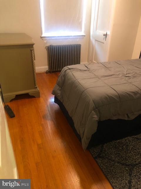 3804 Kimble Road Baltimore, MD 21218 - Photo 7 of 16 a bed sitting in a bedroom next to a window