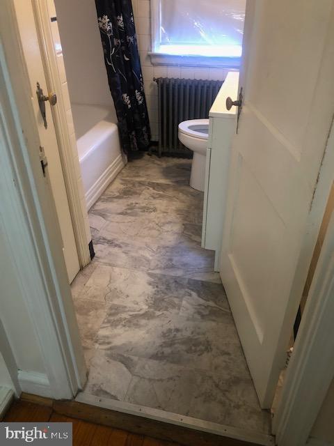 3804 Kimble Road Baltimore, MD 21218 - Photo 8 of 16 a view of a hallway with wooden walls and stairs