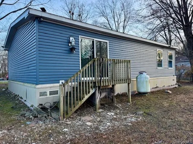 a view of a house with a yard and deck
