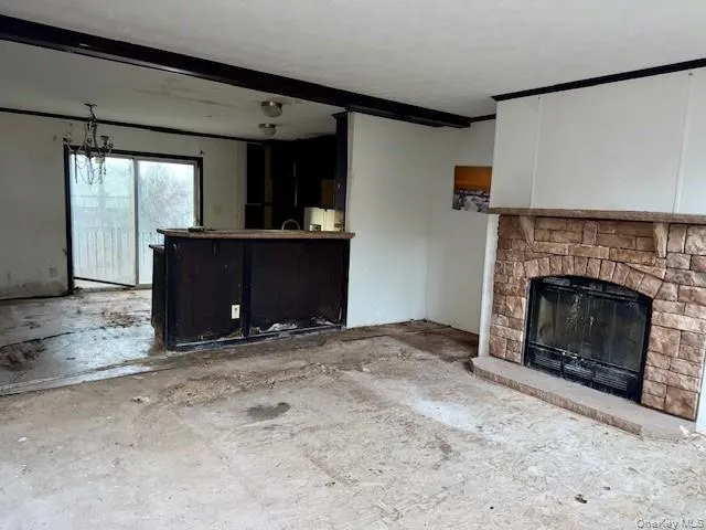 a view of an empty room with a fireplace and a window